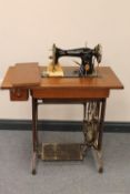 A Singer treadle sewing machine in oak table