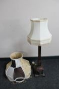 A carved oak Gothic style table lamp with shade together with an ornate standard lamp shade
