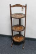 An Eastern inlaid three tier folding cake stand