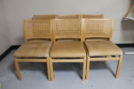 A set of six beech bergere backed leather seated dining chairs