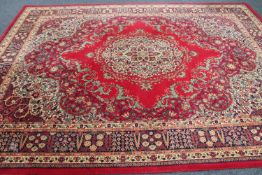 A machine made floral carpet on red ground