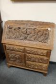 A profusely carved hardwood Indian bureau,