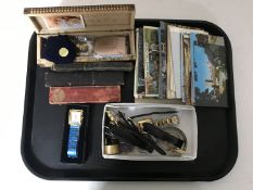 A tray containing lady's and gent's wristwatches, costume jewellery, postcards,