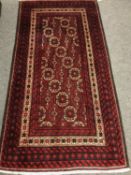 A Persian rug, on red ground,