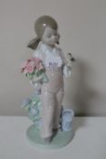 A Lladro figure of a girl with bird on hand