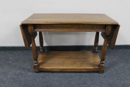 An oak flap sided two tier coffee table