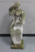 A concrete garden figure, abstract lady,