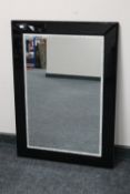 A contemporary all glass framed mirror