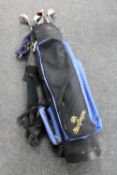 A MacGregor golf bag containing a set of hippo irons and assorted drivers
