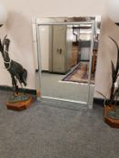 A contemporary glass framed mirror,