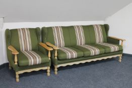 A blonde oak framed three seater settee and armchair in green striped fabric
