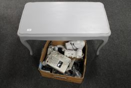 A box of home phones and a painted coffee table