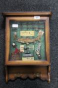 A wall mounted key cabinet containing a fishing montage