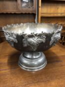 A large plated punch bowl decorated with grapes and grape leaves