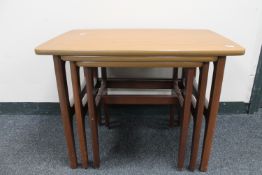A nest of three mid 20th century teak tables