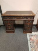 A Victorian heavily carved oak twin pedestal desk,