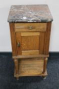 An Edwardian oak marble topped pot cupboard