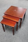 A nest of three mahogany tables