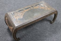 A carved Eastern coffee table