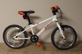 A boy's Carrera Cosmos 16 mountain bike