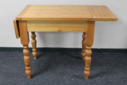 A pine farmhouse table with folding top