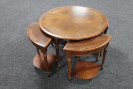A circular mahogany nest of tables