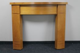 A contemporary pine effect fire surround