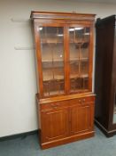 A yew wood glazed bookcase,