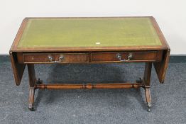 A nest of three mahogany glass and leather topped tables together with a mahogany flap sided sofa
