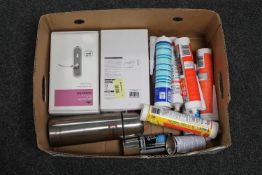 A box of brass door handles, sealants, flask,