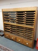 An early 20th century haberdashery chest fitted forty-four pull out drawers and four drawers