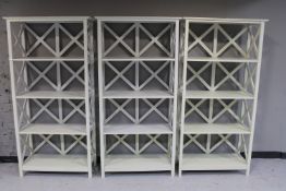 Three sets of painted open bookshelves