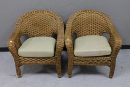 A pair of wicker conservatory armchairs