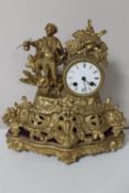 A late 19th century gilt figural mantel clock with enamelled dial,
