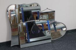 An early twentieth century oval chrome framed mirror together with a metal framed mirror and two