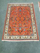 A Malayer rug, on salmon ground,