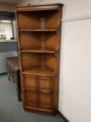 An Ercol elm corner cabinet,