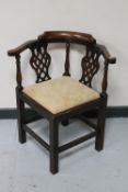 An Edwardian mahogany corner chair