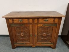 A carved oak double door sideboard,