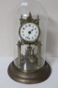 A German brass anniversary clock under glass dome