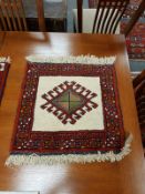 A Caucasian fringed mat on red ground 55 cm x 55 cm