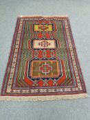 A Caucasian rug on red ground,