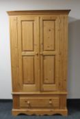 A pine double door hanging wardrobe