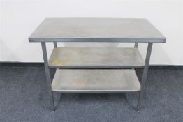 A stainless steel three tier prep table