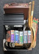 A box of leather case, Christmas decorations, framed black and white photographs, tennis rackets,