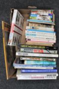 A box of books relating to war and military uniforms