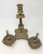 A pair of copper finished brass Arts and Crafts chamber sticks together with a matching candlestick.