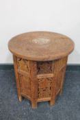 A carved Eastern hardwood folding table