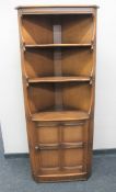 An Ercol corner cabinet