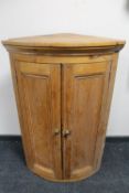 A Victorian pine double door bowfront corner cabinet